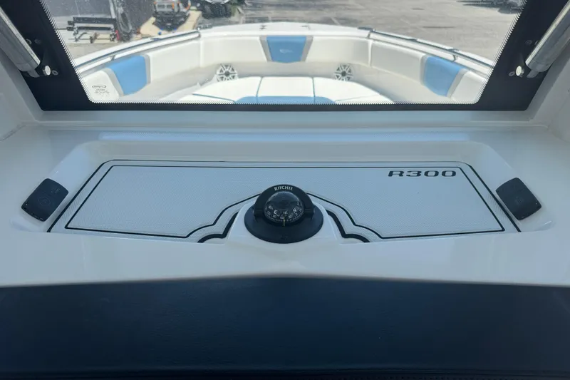 Slide: The Image of 2026 Robalo R300 Center Console boat interior with compass and seating. - 24