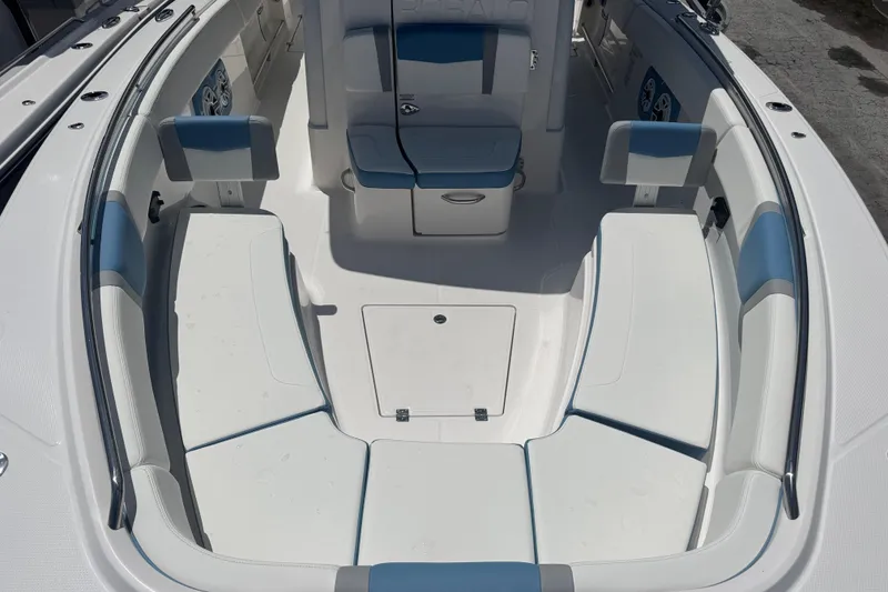 Slide: The Image of 2026 Robalo R300 Center Console boat interior with white and blue seating. - 26