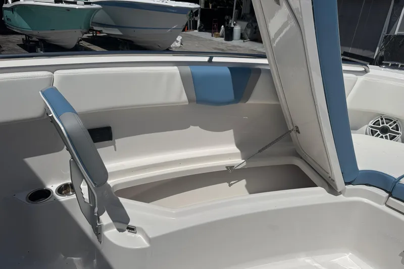 Slide: The Image of 2026 Robalo R300 Center Console boat with open storage compartment and seating. - 38