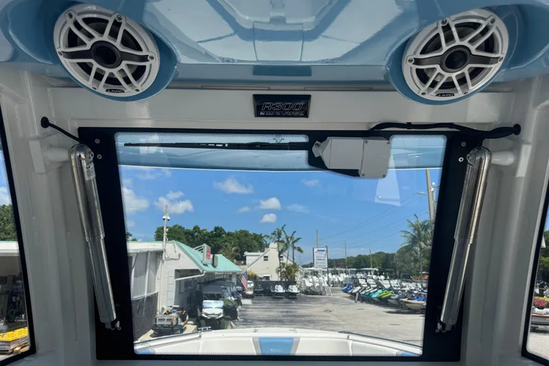 Slide: The Image of 2026 Robalo R300 Center Console boat interior with speakers and marina view. - 40