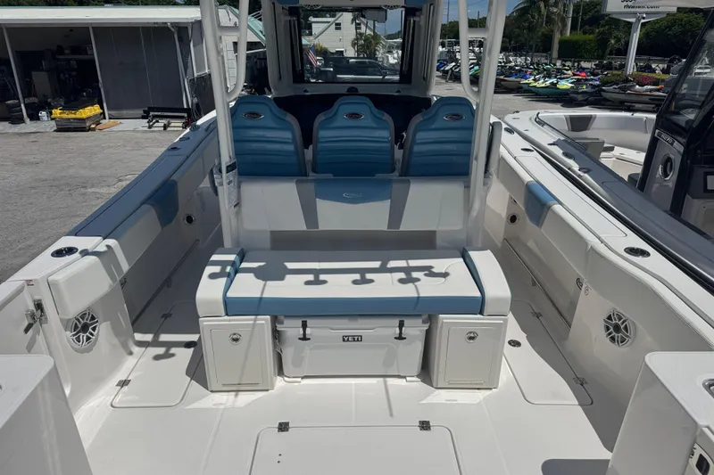 Slide: The Image of 2026 Robalo R300 Center Console boat interior with blue seating and storage compartments. - 6