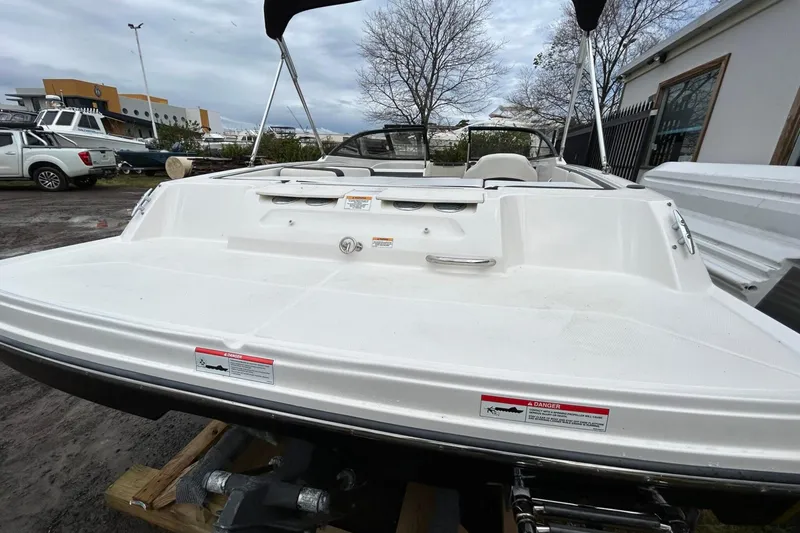 Slide: The Image of 2021 Bayliner VR4 Bowrider OB, white exterior, parked outdoors on a trailer. - 10