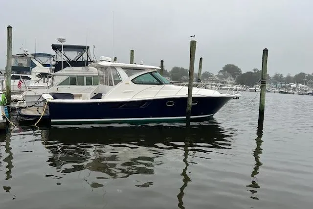 The Image of 2014 Tiara Yachts 3900 Coronet docked in a marina on a cloudy day. - 0