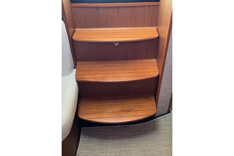 Slide: The Image of Wooden steps inside a 2014 Tiara Yachts 3900 Coronet, showcasing elegant interior design. - 16