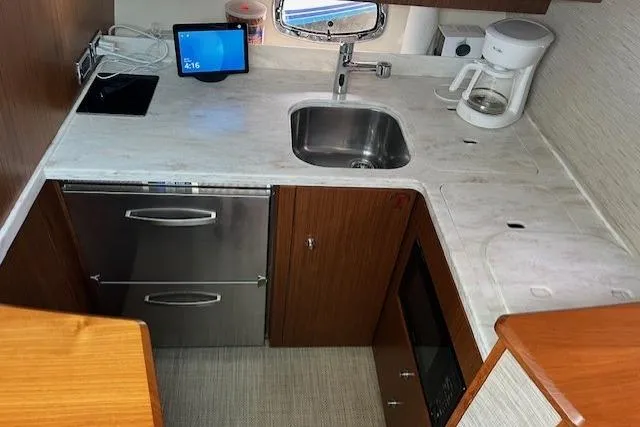 Slide: The Image of 2014 Tiara Yachts 3900 Coronet galley with sink, coffee maker, and modern appliances. - 20