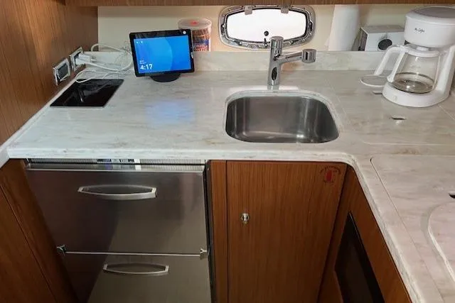 Slide: The Image of 2014 Tiara Yachts 3900 Coronet kitchen with sink, stove, fridge, and coffee maker. - 21