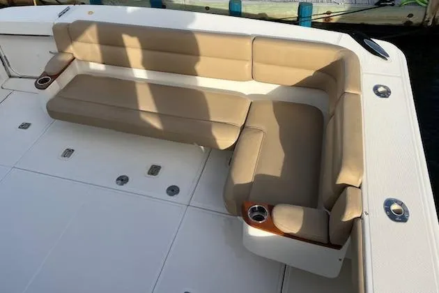 Slide: The Image of 2014 Tiara Yachts 3900 Coronet, beige seating area with cup holders on deck. - 24