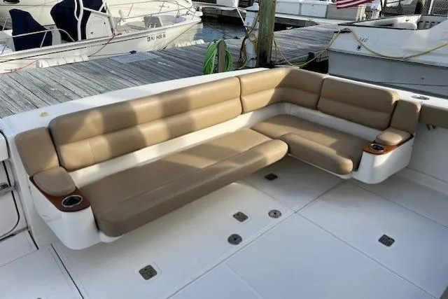 Slide: The Image of 2014 Tiara Yachts 3900 Coronet with beige seating on deck, docked at marina. - 25