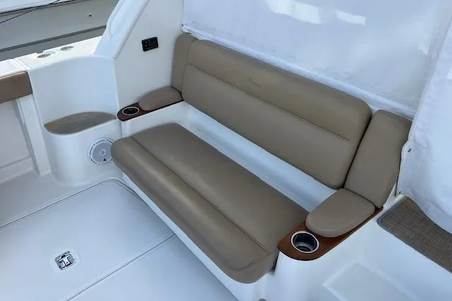 Slide: The Image of 2014 Tiara Yachts 3900 Coronet interior with beige seating and cup holders. - 26