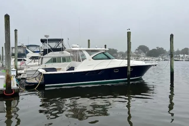 Slide: The Image of 2014 Tiara Yachts 3900 Coronet docked in a marina on a cloudy day. - 4