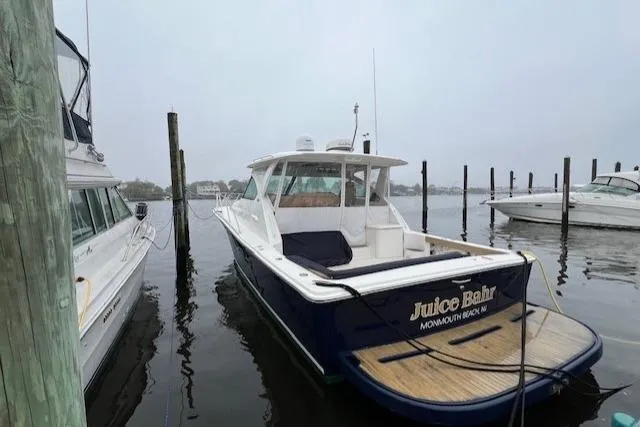Slide: The Image of 2014 Tiara Yachts 3900 Coronet docked in a marina, rear view. - 5