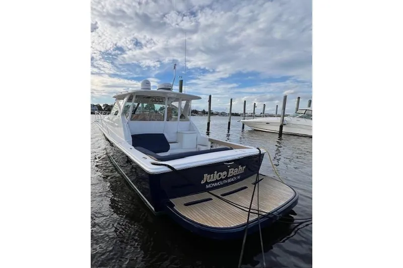 Slide: The Image of 2014 Tiara Yachts 3900 Coronet docked, featuring sleek design and spacious deck. - 7