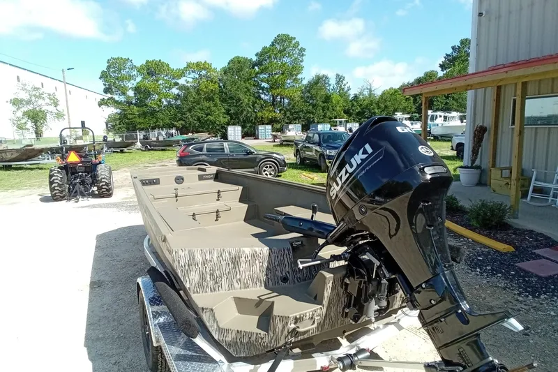 Slide: The Image of 2026 Thor 1754 Timber Hammer boat with Suzuki outboard motor in outdoor setting. - 10