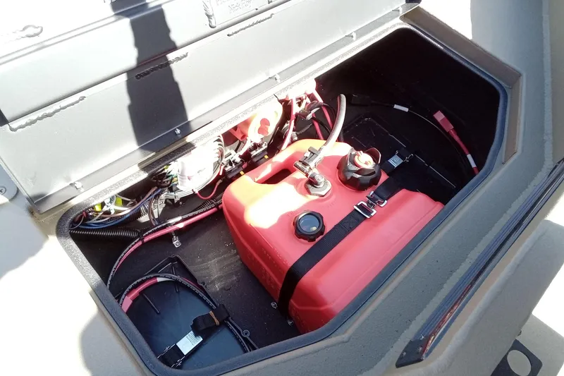 Slide: The Image of Open storage compartment of 2026 Thor 1754 Timber Hammer with red fuel tank and wiring. - 13
