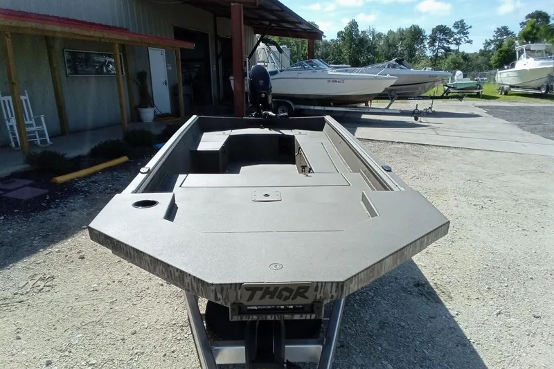 Slide: The Image of 2026 Thor 1754 Timber Hammer boat displayed outdoors, surrounded by other boats. - 5