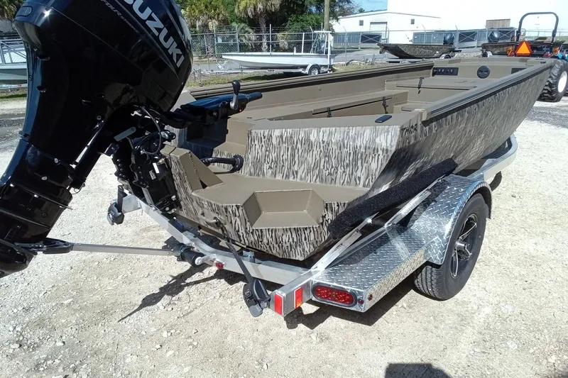 Slide: The Image of 2026 Thor 1754 Timber Hammer boat with Suzuki outboard motor on a trailer. - 8