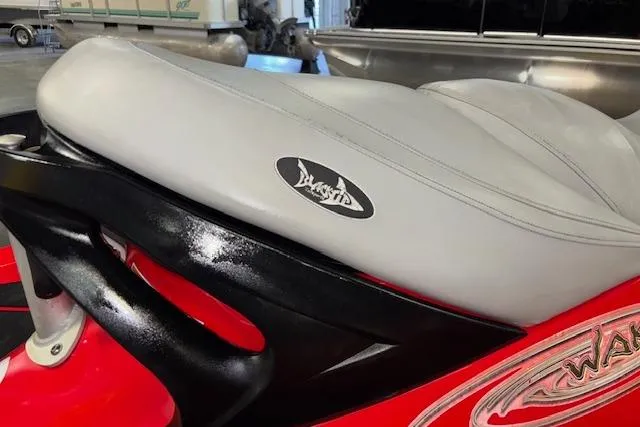 Slide: The Image of 2005 Sea-Doo Wake 155 jet ski seat, featuring a sleek gray design and logo. - 12