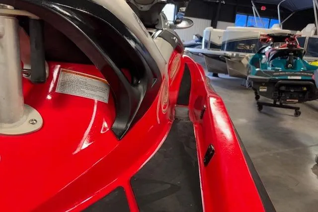 Slide: The Image of 2005 Sea-Doo Wake 155 jet ski in a showroom, vibrant red color. - 9
