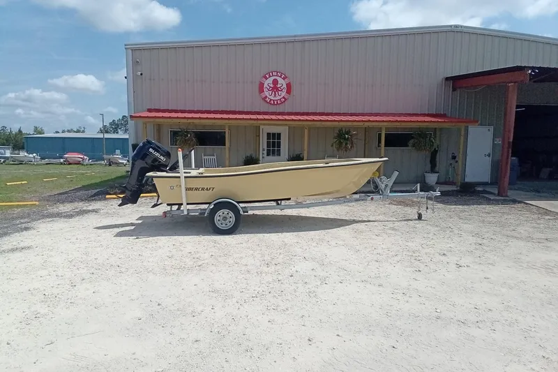 Slide: The Image of 2025 Fibercraft F16 boat on trailer outside a building with red roof. - 3