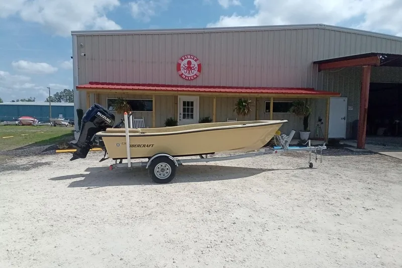 Slide: The Image of 2025 Fibercraft F16 boat on trailer outside a building with red roof. - 7