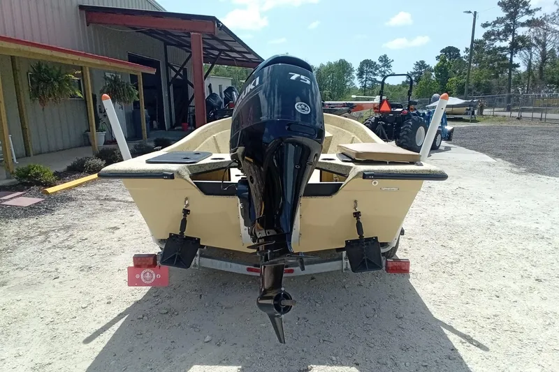 Slide: The Image of 2025 Fibercraft F16 boat with Suzuki 75 outboard motor, parked outdoors. - 9