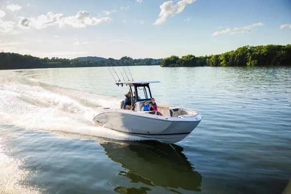 The Image of 2026 Yamaha Boats 255 FSH Sport H cruising on a serene lake under a clear sky. - 1