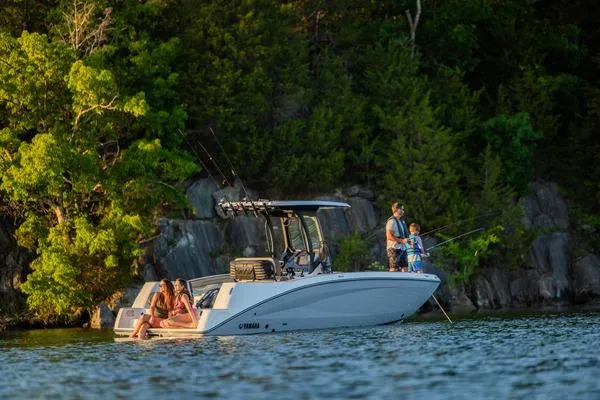 Slide: The Image of 2026 Yamaha Boats 255 FSH Sport H on a serene lake, surrounded by lush greenery. - 5