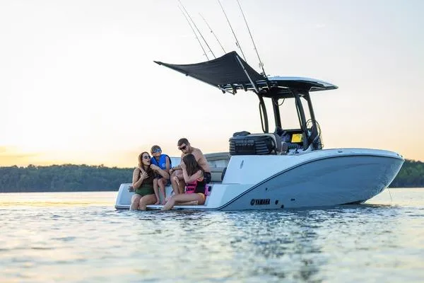 Slide: The Image of 2026 Yamaha Boats 255 FSH Sport H with people enjoying a day on the water. - 8