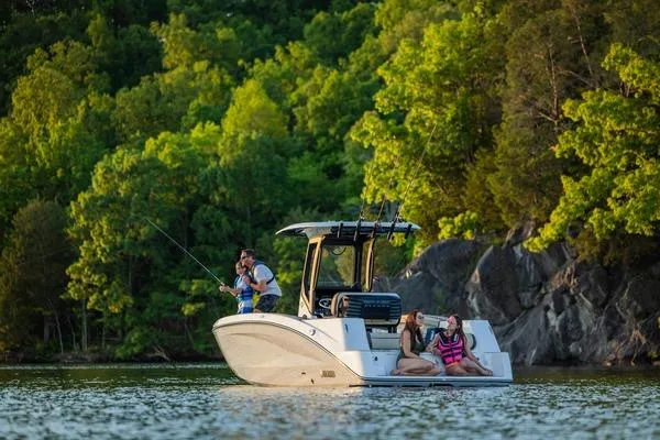Slide: The Image of 2026 Yamaha Boats 255 FSH Sport H on a scenic lake with passengers fishing. - 9
