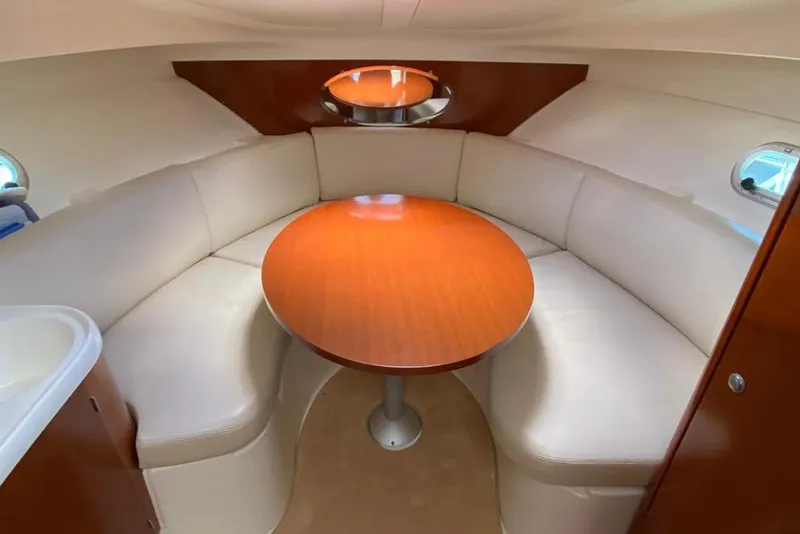 Slide: The Image of Interior of 2008 Jeanneau Leader 805 with round table and cushioned seating. - 4
