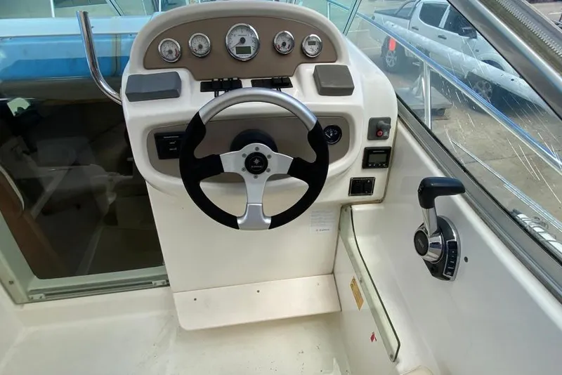 Slide: The Image of Steering console of a 2008 Jeanneau Leader 805 boat with gauges and controls. - 7