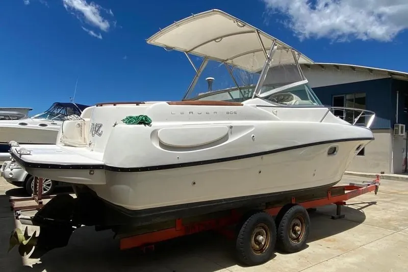 Slide: The Image of 2008 Jeanneau Leader 805 boat on trailer under clear blue sky. - 9