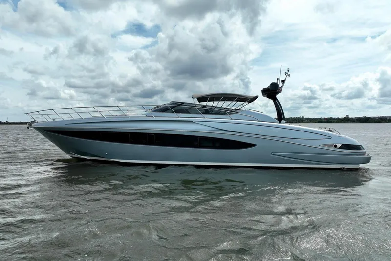 Slide: The Image of 2016 Riva 63 Virtus yacht on open water under cloudy sky. - 18
