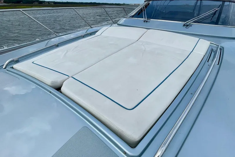 Slide: The Image of 2016 Riva 63 Virtus yacht with spacious sunbathing deck, docked by the water. - 25