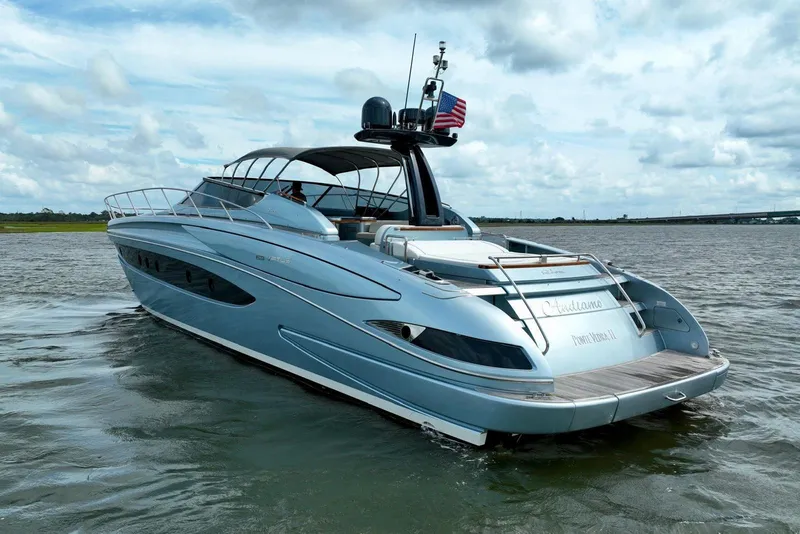 Slide: The Image of 2016 Riva 63 Virtus yacht cruising on open water under a cloudy sky. - 4