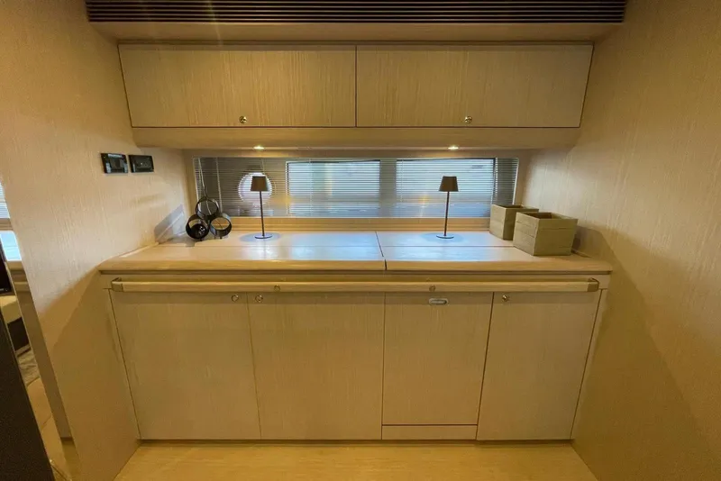 Slide: The Image of Luxurious interior of 2016 Riva 63 Virtus yacht with elegant wooden cabinetry and modern decor. - 40