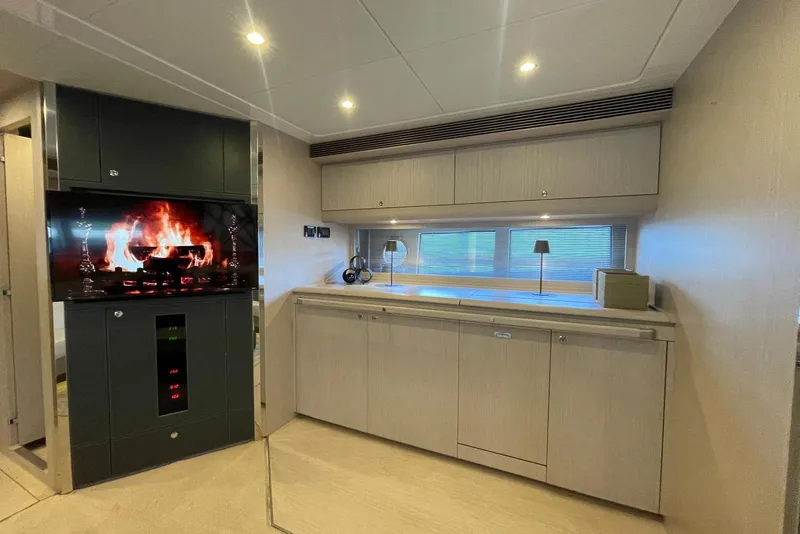 Slide: The Image of Luxurious interior of 2016 Riva 63 Virtus yacht with modern fireplace and sleek cabinetry. - 41