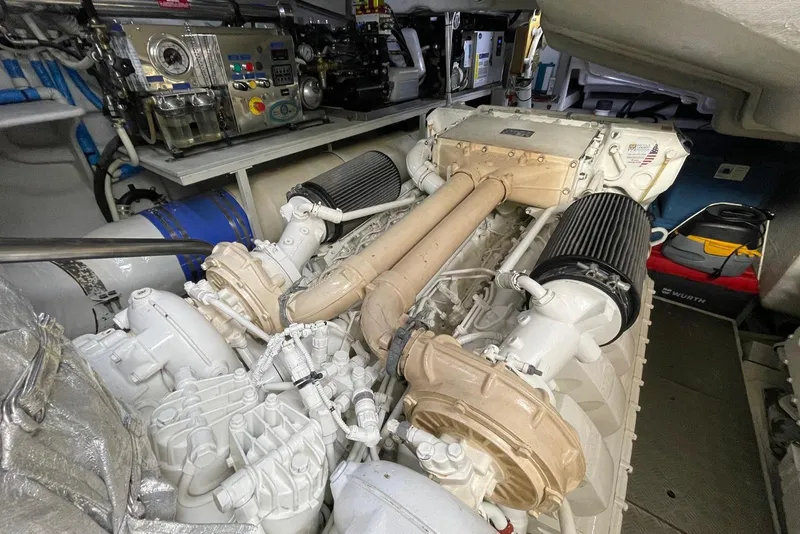 Slide: The Image of Engine room of a 2016 Riva 63 Virtus yacht, showcasing complex machinery and components. - 56