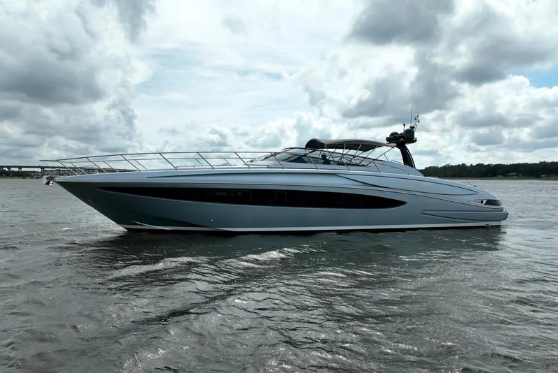 Slide: The Image of 2016 Riva 63 Virtus luxury yacht on calm waters under cloudy skies. - 7