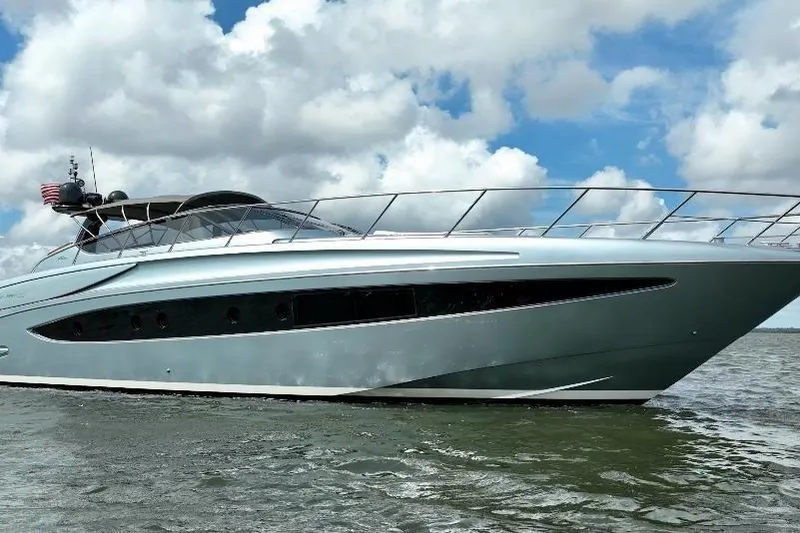 Slide: The Image of 2016 Riva 63 Virtus yacht cruising on open water under a cloudy sky. - 8