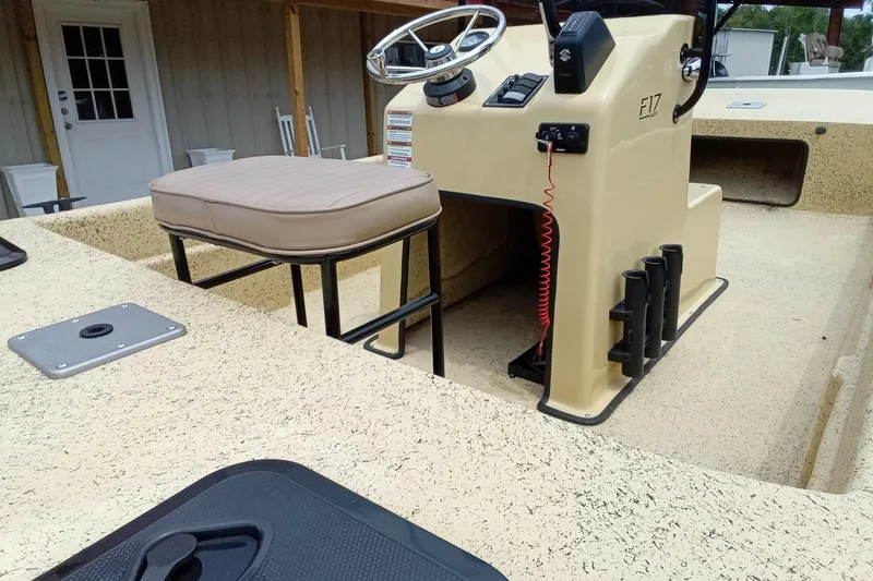 Slide: The Image of Fibercraft F17 boat interior, 2025 model, featuring steering console and seating. - 12