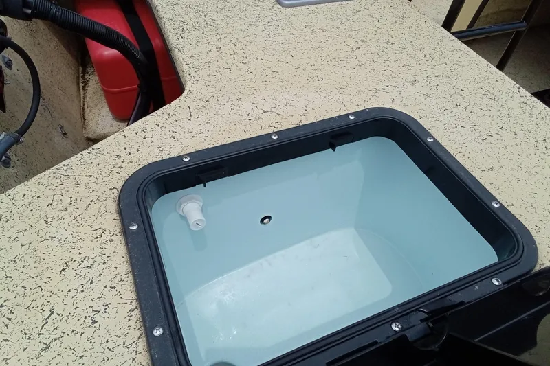 Slide: The Image of Fibercraft F17 2025 boat interior with open storage compartment and visible wiring. - 13