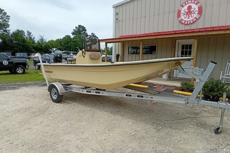 Slide: The Image of 2025 Fibercraft F17 boat on trailer outside a building with red roof. - 4