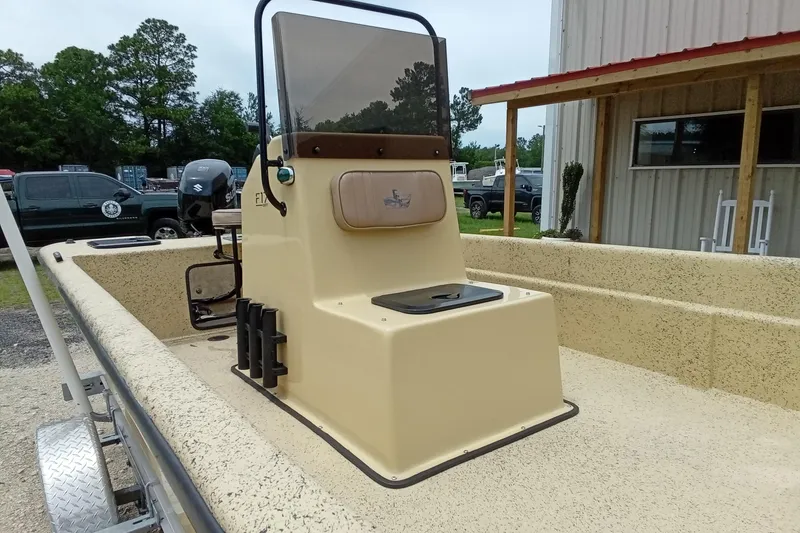 Slide: The Image of 2025 Fibercraft F17 boat with beige interior, parked outdoors near a building. - 6