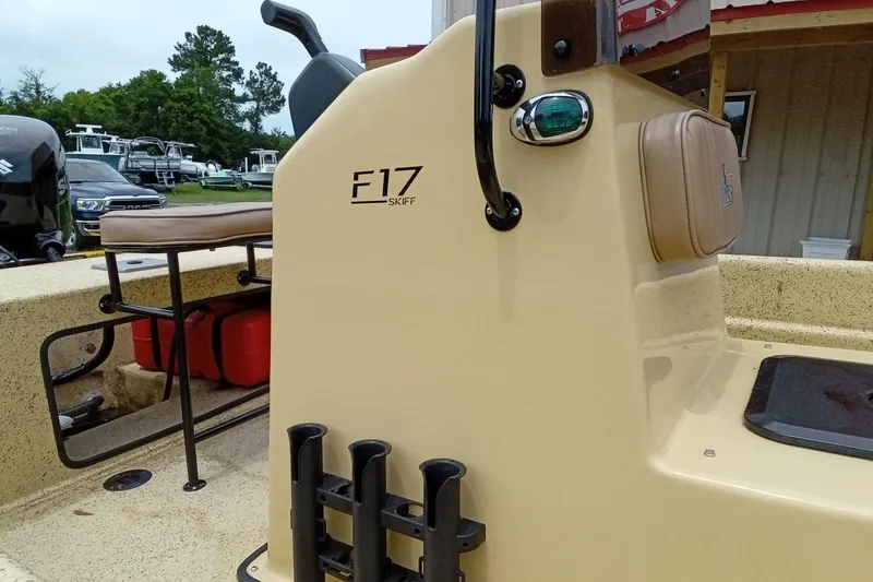 Slide: The Image of 2025 Fibercraft F17 Skiff boat with beige console and seating, docked outdoors. - 7