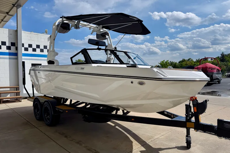 Slide: The Image of 2026 Nautique Super Air Nautique GS20 boat on trailer, parked outdoors under a blue sky. - 10