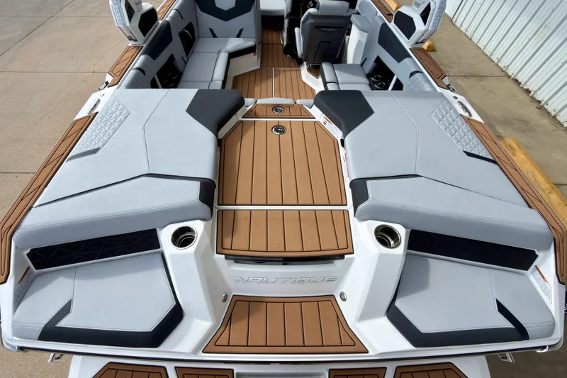 Slide: The Image of 2026 Nautique Super Air Nautique GS20 boat interior with sleek seating and wood accents. - 12