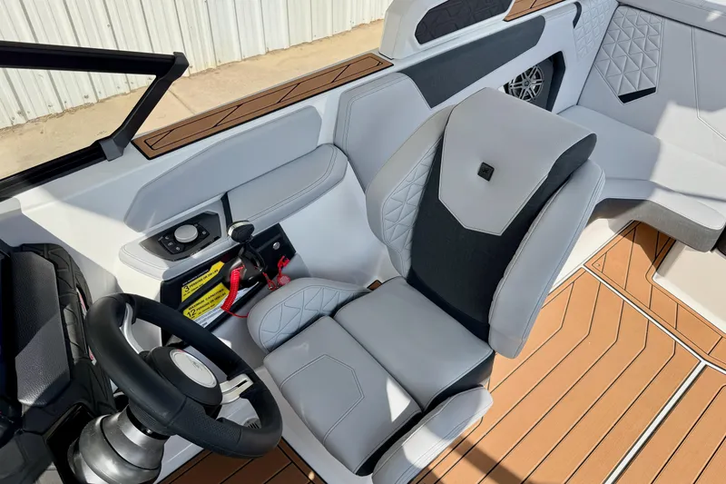 Slide: The Image of 2026 Nautique Super Air Nautique GS20 cockpit with modern steering and luxurious seating. - 15