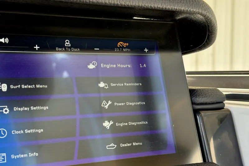 Slide: The Image of Touchscreen display of 2026 Nautique Super Air Nautique GS20 showing engine hours and settings menu. - 17