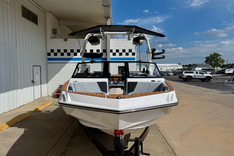 Slide: The Image of 2026 Nautique Super Air Nautique GS20 boat on trailer, parked outdoors. - 2